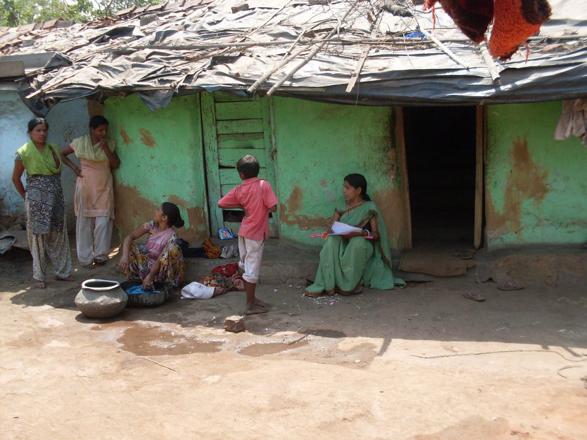 Ministry team comforting a struggling mother and praying with children outside their home